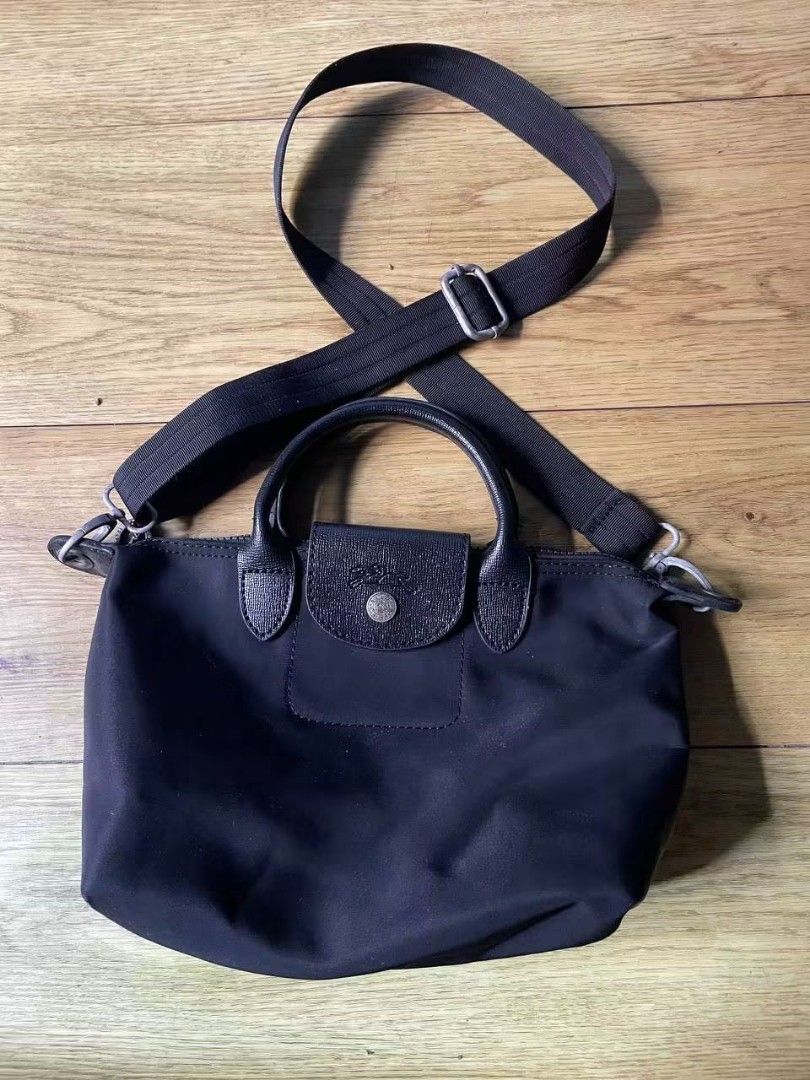 Longchamp Paris Nylon Top Handle Bag (Category: Luxury Bags & Wallets) located in Manila. Submitted by gbryanrave27905 (Listing ID 1464356844, Image 1). Description: 📌 Authentic Longchamp Paris black nylon top handle bag 📌 Made in France 📌 Features a detachable shoulder strap for versatile carrying 📌 Includes an interior zippered pocket for secure storage 📌Ideal everyday bag, perfectly sized for your essentials 📌issue none 📌colorrate 10/10