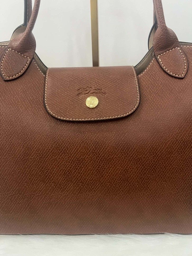 Longchamp Tote Bag (Category: Luxury Bags & Wallets) located in Paoay. Submitted by rvf1230 (Listing ID 1464397063, Image 3). Description: - Classic Longchamp tote bag - Rich brown color - Durable leather with embossed horse logo - Snap closure - Comfortable shoulder straps - Spacious interior for daily essentials - Timeless wardrobe piece.