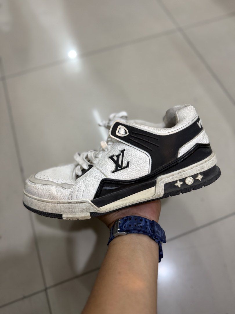 Louis Vuitton LV Trainers White Black (Category: Sneakers & Footwear) located in Bacolod City. Submitted by kitcarsonduff (Listing ID 1464421761, Image 3). Description: - Authentic Louis Vuitton sneakers - Color: White with black accents - Features iconic LV logo on the side and tongue - Distinctive '#54' and 'VUITTON' detailing on the back - Soles show some wear but retain plenty of grip - Ideal for casual and everyday wear.