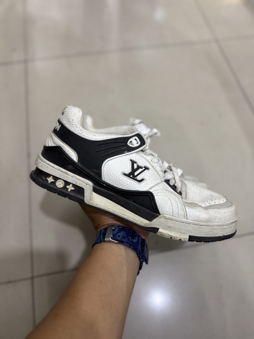 Louis Vuitton LV Trainers White Black (Category: Sneakers & Footwear) located in Bacolod City. Submitted by kitcarsonduff (Listing ID 1464421761, Image 2). Description: - Authentic Louis Vuitton sneakers - Color: White with black accents - Features iconic LV logo on the side and tongue - Distinctive '#54' and 'VUITTON' detailing on the back - Soles show some wear but retain plenty of grip - Ideal for casual and everyday wear.