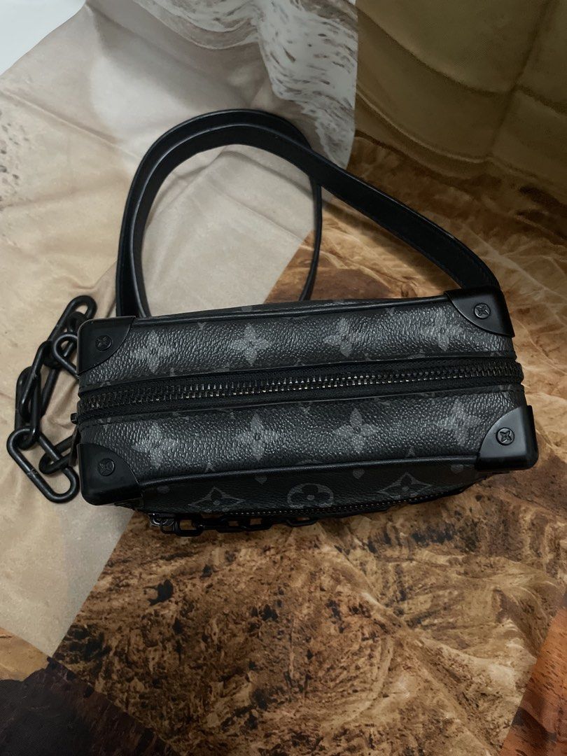 Louis Vuitton Monogram Trunk Bag Black (Category: Luxury Bags & Wallets) located in Cagayan de Oro. Submitted by luxieebags (Listing ID 1464547655, Image 2). Description: - Authentic Louis Vuitton trunk bag - Classic black monogram pattern - Versatile with both a black chain strap and a leather shoulder strap - Secure zipper closure on top - Small and compact size, ideal for carrying essentials.