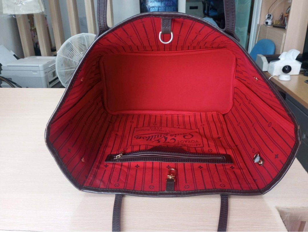 Louis Vuitton Neverfull Damier Ebene Tote Bag (Category: Luxury Bags & Wallets) located in Quezon City. Submitted by christelleannesy (Listing ID 1464481016, Image 2). Description: - Classic Louis Vuitton Neverfull tote - Damier Ebene canvas with striking red interior - Ample space for all your essentials - Includes an interior zippered pocket and D-ring - Durable leather straps - Adjustable drawstring sides for customized capacity - Ideal everyd
