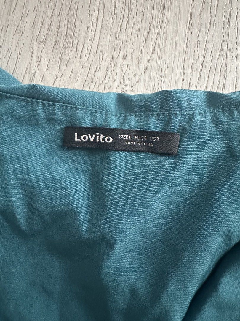 Lovito Teal Ruffle Wrap Midi Dress Size L (Category: Dresses) located in Makati City. Submitted by msjlarsen (Listing ID 1464462203, Image 2). Description: - Lovito Teal Midi Wrap Dress - used only once - Size: M to L - Model height 5’w - Style: Wrap with tie waist - Details: Ruffle neckline and hem, sleeveless - Occasion: Great for events or a night out/ beach summer wrap around .