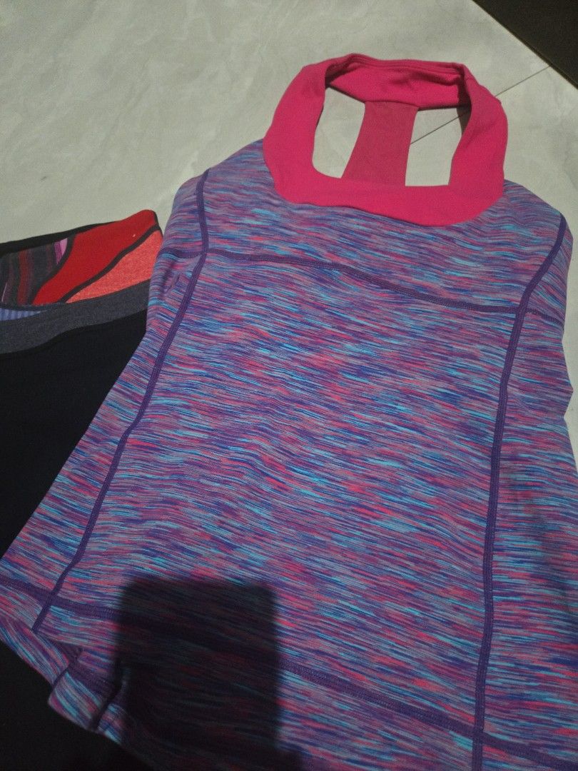 Authentic Lululemon Athletic Top and Leggings Set (Category: Activewear) located in Pasig City. Submitted by izzy0202 (Listing ID 1464395153, Image 2). Description: - Lululemon athletic top with a vibrant, colorful marled pattern. - Features a stylish pink racerback design. - Matching black leggings with a unique colorful waistband. - Both pieces display the iconic Lululemon logo. - Versatile for gym sessions or everyday casual wear. purchased in
