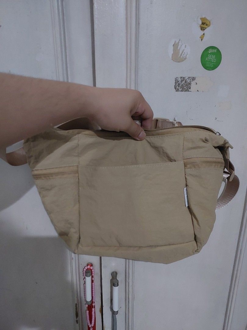 Lululemon Beige Slouchy Sling Bag 6L (Category: Cross-body Bags) located in Quezon City. Submitted by manilahaulph (Listing ID 1464552592, Image 2). Description: - Beige Lululemon sling bag - Main zip compartment - Front pocket - Adjustable strap - Clean inside and out - Ideal for everyday use.