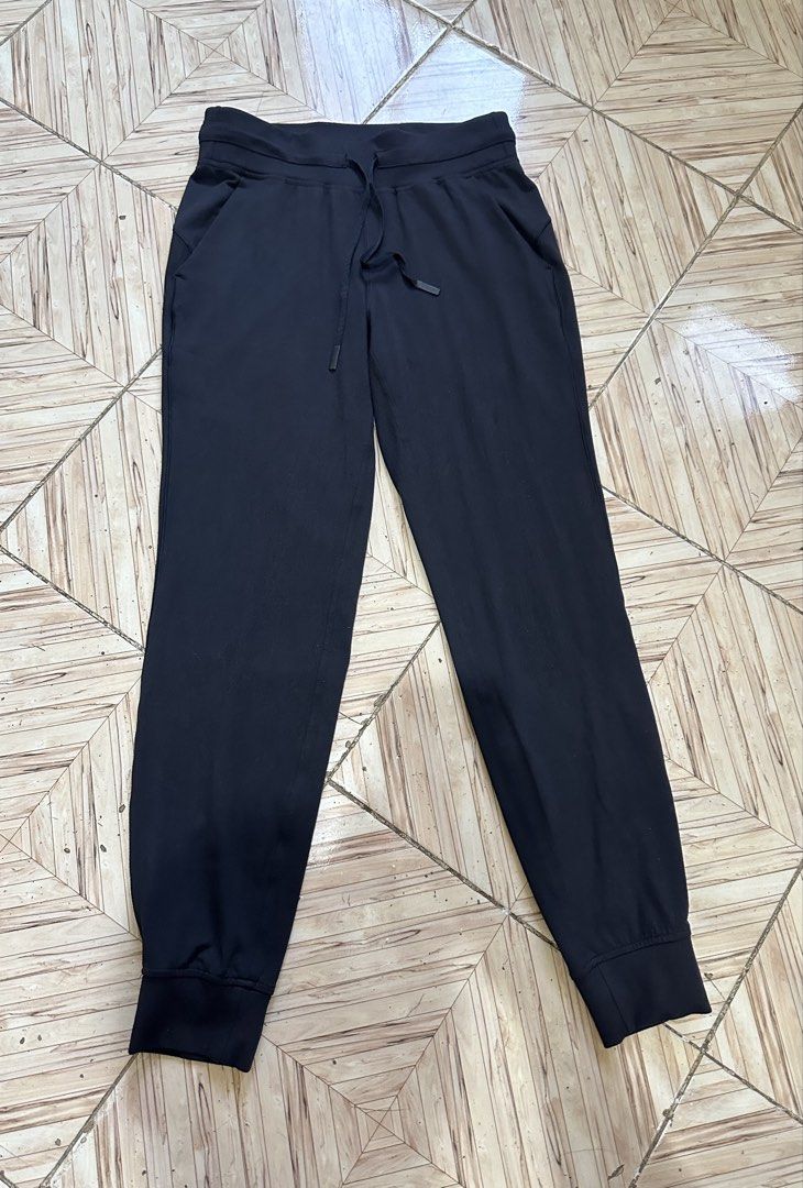 Lululemon Black Jogger Pants Size 6 (Category: Joggers) located in Angeles City. Submitted by alejeong27 (Listing ID 1464435355, Image 1). Description: - Black Lululemon joggers - Comfortable and stretchy material - Elastic waistband with adjustable drawstring - Cuffed ankles for a sleek look - Versatile: great for workouts or lounging - Features convenient pockets - Subtle Lululemon logo on back leg and inside waistband.