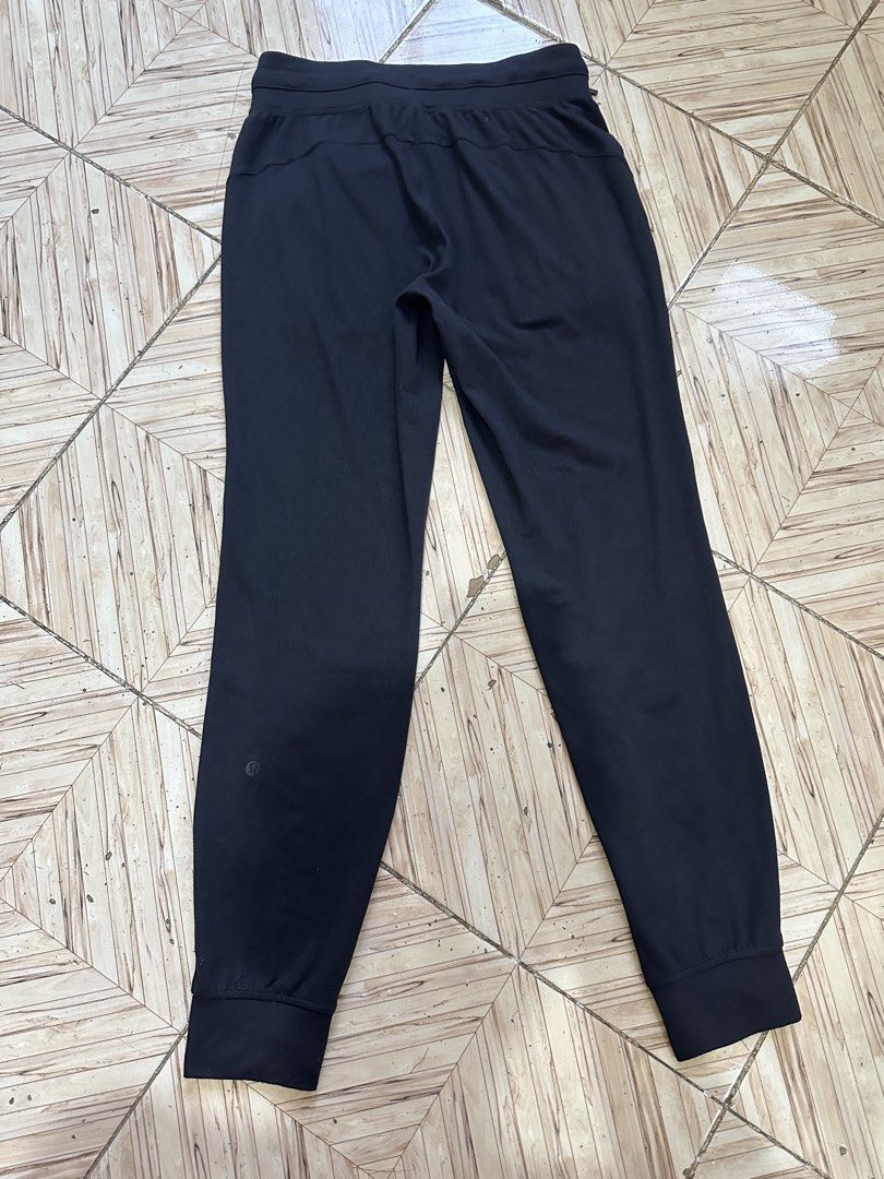Lululemon Black Jogger Pants Size 6 (Category: Joggers) located in Angeles City. Submitted by alejeong27 (Listing ID 1464435355, Image 2). Description: - Black Lululemon joggers - Comfortable and stretchy material - Elastic waistband with adjustable drawstring - Cuffed ankles for a sleek look - Versatile: great for workouts or lounging - Features convenient pockets - Subtle Lululemon logo on back leg and inside waistband.