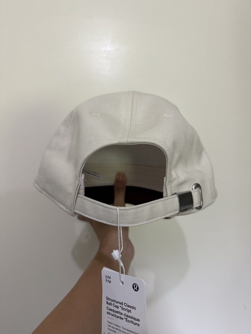 Lululemon Structured Classic Ball Cap Script (Category: Activewear) located in Manila. Submitted by katsinlao (Listing ID 1464414134, Image 2). Description: Details: • Color: White with maroon brim • Size: S/M - Brand new and original tag still attached - Purchased in Utah 🇺🇸 Payment: - Payment first policy - Gcash - Maya - GoTyme - COD (if lalamove) - Cash (if meet up).