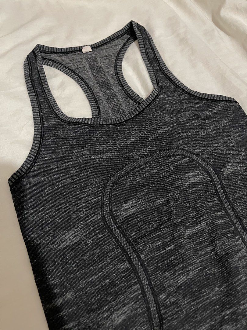 Lululemon Swiftly Tech Racerback Tank Top (Category: Activewear) located in Makati City. Submitted by afterpiece (Listing ID 1464478217, Image 2). Description: Lululemon Swiftly Tech Racerback tank in heathered black/grey. "Sweat Life" and "I Run For Cheese" Size 4, refer to photos for measurement.
