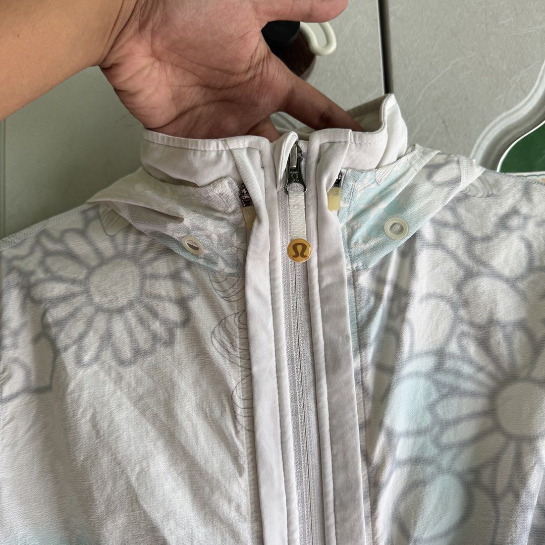 Lululemon White Floral Hooded Lightweight Jacket (Category: Coats, Jackets and Outerwear) located in Manila. Submitted by zennyaur (Listing ID 1464419459, Image 3). Description: White Lululemon floral print hooded jacket. Lightweight with adjustable waist drawstring and two zip pockets. Perfect for workouts or casual wear, and easy to pack..