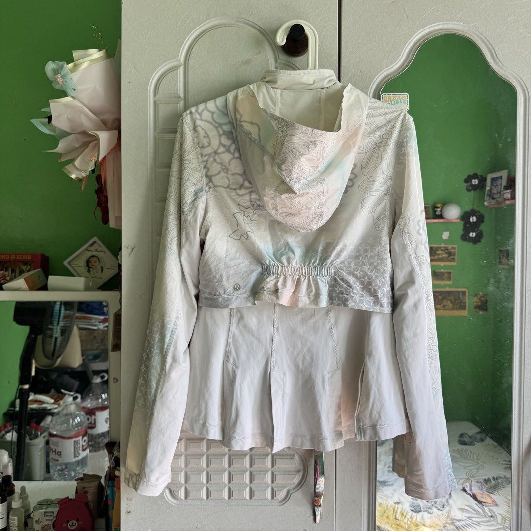 Lululemon White Floral Hooded Lightweight Jacket (Category: Coats, Jackets and Outerwear) located in Manila. Submitted by zennyaur (Listing ID 1464419459, Image 2). Description: White Lululemon floral print hooded jacket. Lightweight with adjustable waist drawstring and two zip pockets. Perfect for workouts or casual wear, and easy to pack..