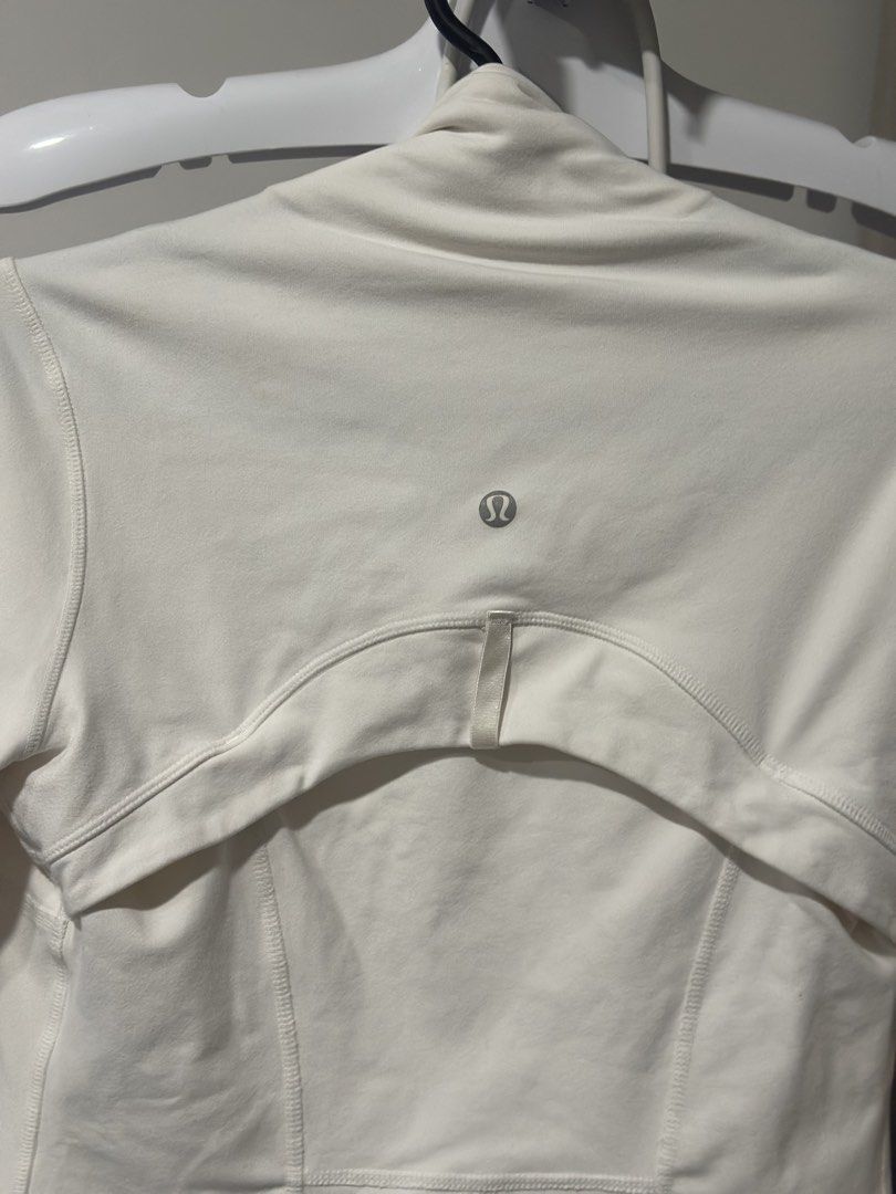 Lululemon White Jacket size 2 (Category: Coats, Jackets and Outerwear) located in Cavite. Submitted by prelovedbymaeve (Listing ID 1464451988, Image 2). Description: - White Lululemon jacket - Full zip closure - Two zip pockets - Thumbholes on sleeves.