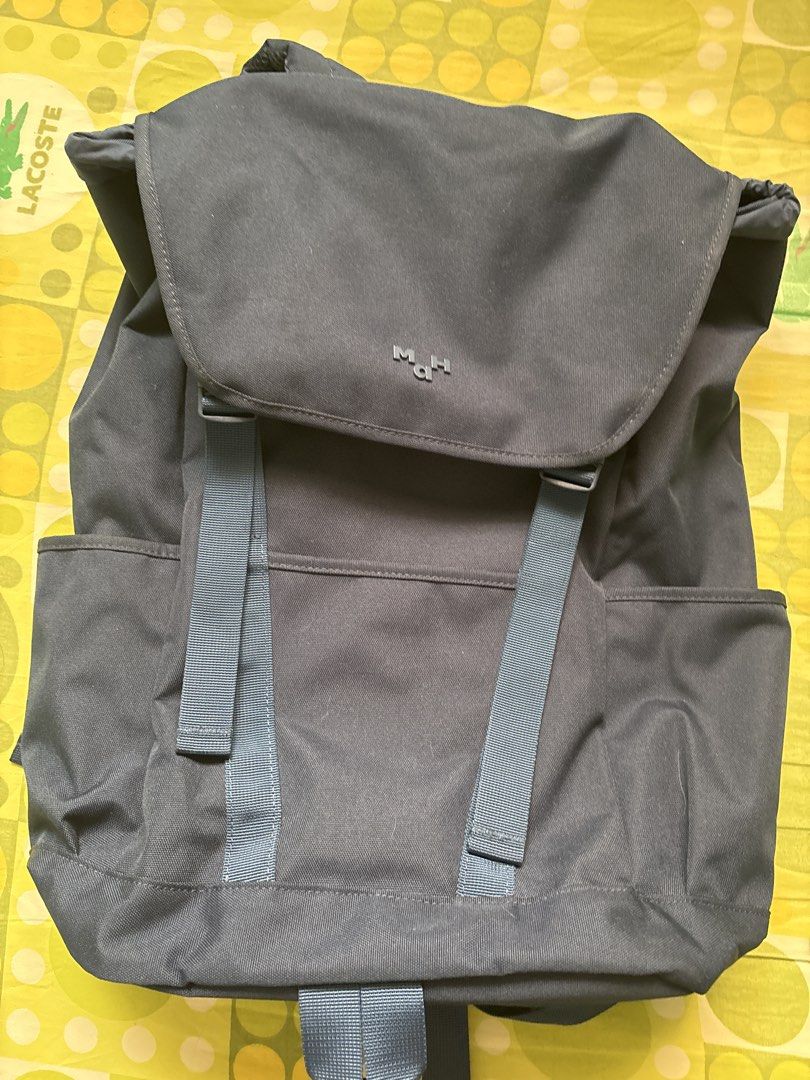 MAH Navy Blue Backpack (Category: Backpacks) located in Taytay. Submitted by justinqt (Listing ID 1464388260, Image 1). Description: - Stylish blue canvas backpack - Secure flap closure - Convenient side pockets for extra storage - Adjustable straps for a comfortable fit - Subtle 'MAH.' embossed logo on the flap - Ideal for everyday use and travel - Can fit 15.6 inch laptops - 1.5 liter bag.