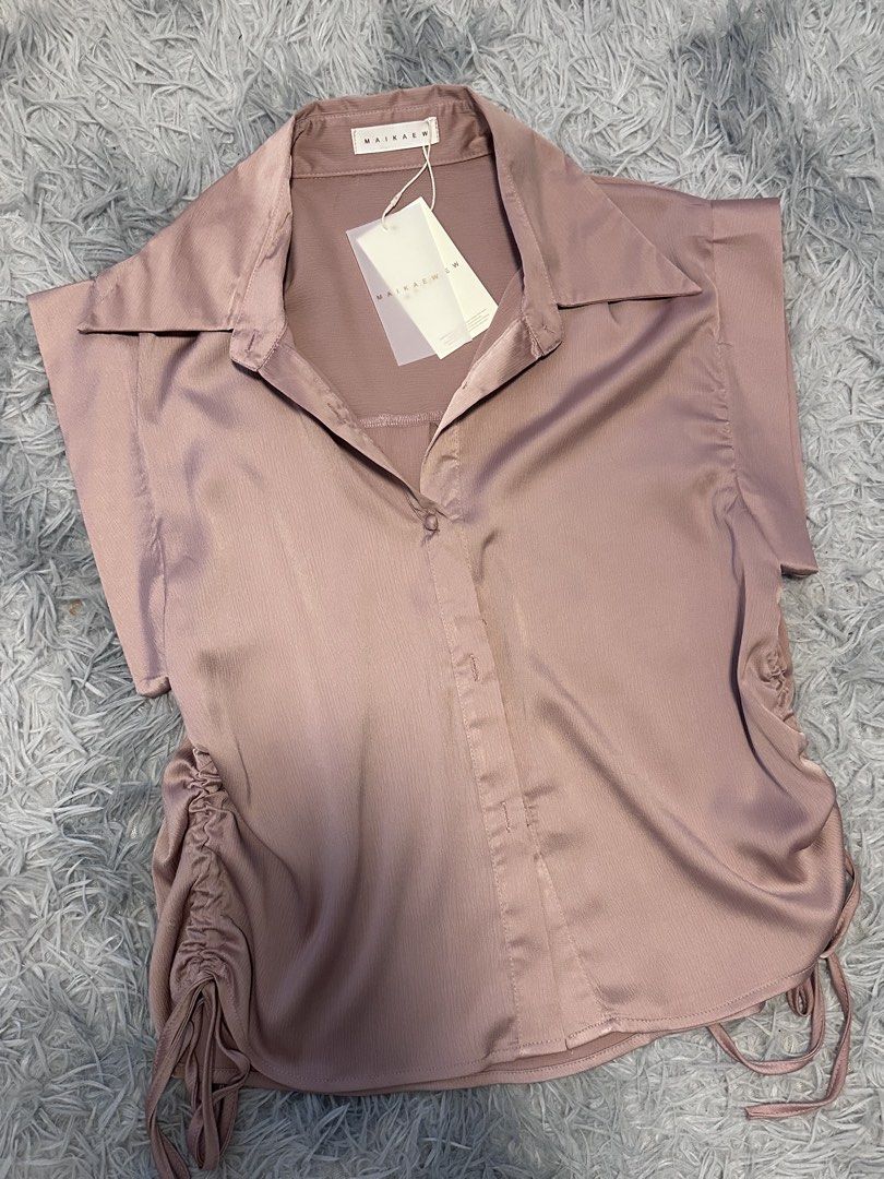 MAIKAEW Pink Ruched Satin Collared Shirt (Category: Blouses) located in Batangas. Submitted by kulilayfinds (Listing ID 1464363547, Image 2). Description: - Brand new pink satin shirt - Collared neckline - Short cap sleeves - Ruched sides with adjustable drawstring ties - Button-up front - Tags still attached - Measurements available in photos.