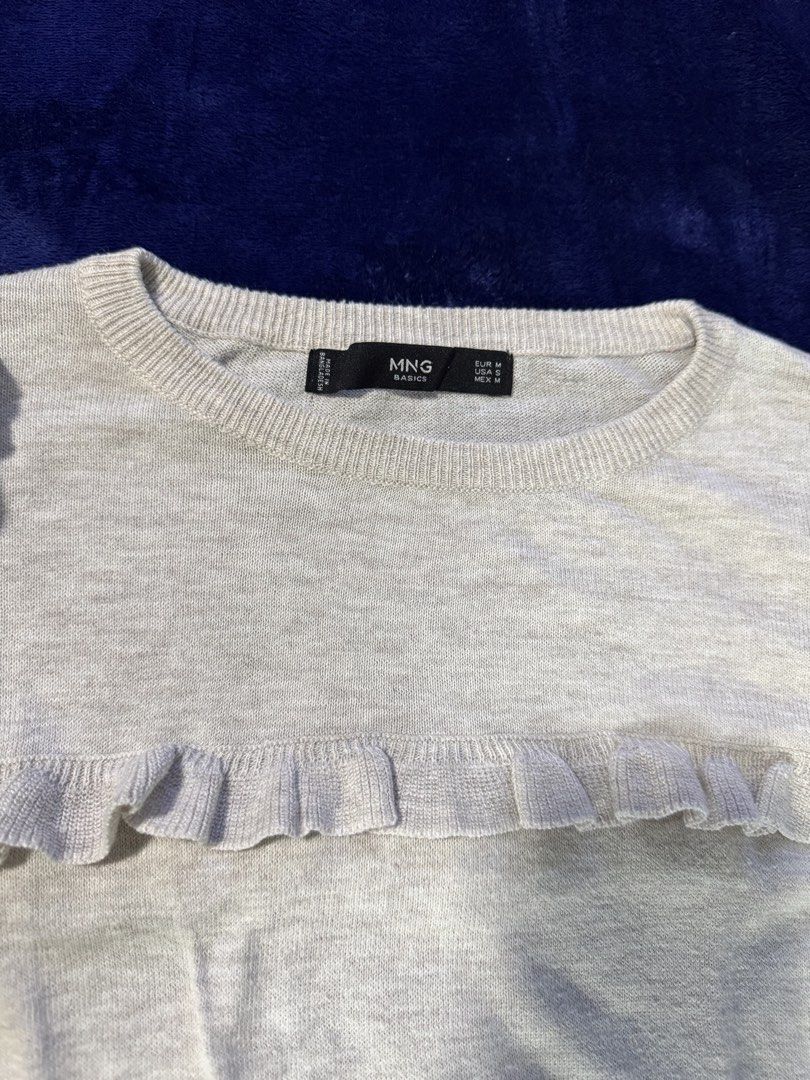 Mango Basics Grey Ruffle Neck Sweater (Category: Longsleeves) located in Quezon City. Submitted by candyclosetph (Listing ID 1464381645, Image 3). Description: - Grey sweater from MNG Basics - Features a cute ruffle detail around the neckline and shoulders - Long sleeves with elasticated cuffs - Comfortable and stylish design - Ideal for layering or wearing on its own.