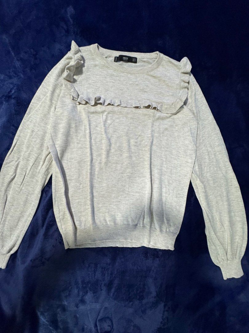 Mango Basics Grey Ruffle Neck Sweater (Category: Longsleeves) located in Quezon City. Submitted by candyclosetph (Listing ID 1464381645, Image 2). Description: - Grey sweater from MNG Basics - Features a cute ruffle detail around the neckline and shoulders - Long sleeves with elasticated cuffs - Comfortable and stylish design - Ideal for layering or wearing on its own.
