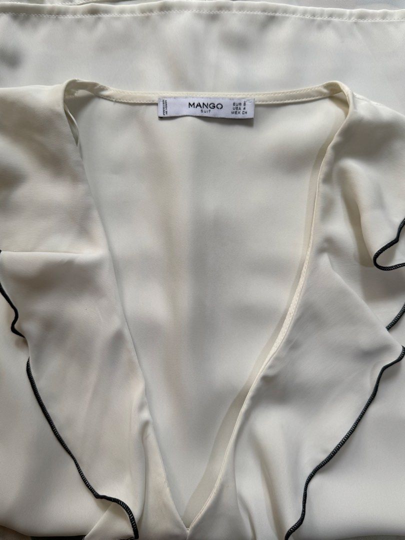 Mango White Ruffle Blouse with Black Trim (Category: Blouses) located in Manila. Submitted by only_alyssacloset (Listing ID 1464398321, Image 2). Description: Mango White Ruffle Blouse with Black Trim Color: White Size: Medium to Large.