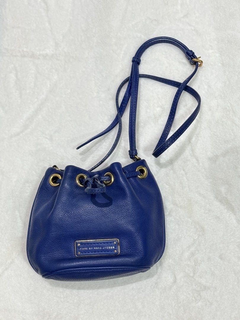 Marc by Marc Jacobs Blue Leather Bucket Bag (Category: Luxury Bags & Wallets) located in San Nicolas. Submitted by ihascat (Listing ID 1464449652, Image 1). Description: - Authentic Marc by Marc Jacobs blue leather bucket bag - Secure drawstring closure with elegant gold hardware - Adjustable shoulder strap for comfortable wear - Minor wear on edges and strap, as shown in photos - Ideal for everyday use, stylish and practical.