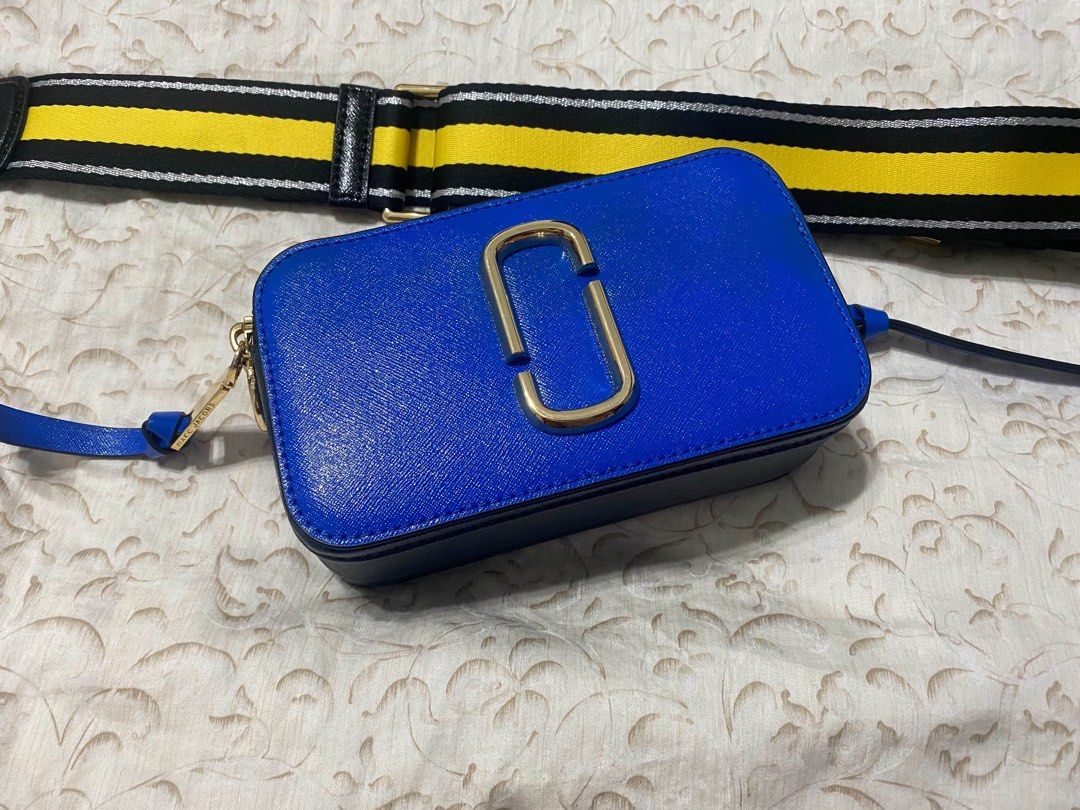 Marc Jacobs Snapshot Camera Bag Blue Yellow Strap (Category: Luxury Bags & Wallets) located in Manila. Submitted by miguelwoii (Listing ID 1464389169, Image 1). Description: - Authentic Marc Jacobs Snapshot Bag - Stunning Bright Blue Leather - Polished Gold Hardware - Comes with iconic Yellow & Black Striped Strap - Includes a Plain Blue Strap - Brand New with Tags Attached - Ideal for Everyday Style & Functionality.