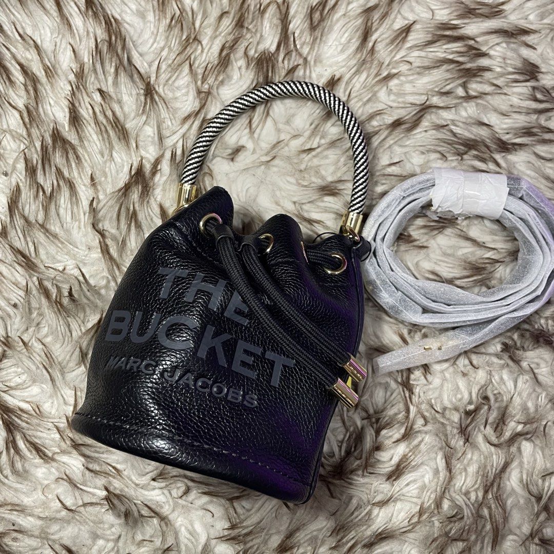 Marc Jacobs The Bucket Bag Black Leather (Category: Luxury Bags & Wallets) located in Marikina City. Submitted by nqshop (Listing ID 1464475067, Image 2). Description: - Authentic Marc Jacobs black leather bucket bag mini - Iconic 'The Bucket' logo embossed on the front - Versatile carrying options: detachable crossbody strap and top handle - Secure drawstring closure - Elegant gold hardware details - Ideal for everyday style and practicality -Wi