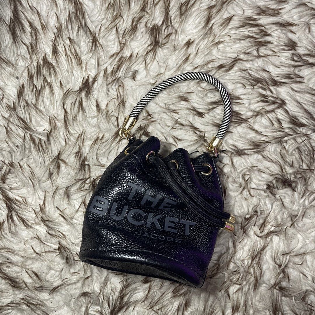 Marc Jacobs The Bucket Bag Black Leather (Category: Luxury Bags & Wallets) located in Marikina City. Submitted by nqshop (Listing ID 1464475067, Image 3). Description: - Authentic Marc Jacobs black leather bucket bag mini - Iconic 'The Bucket' logo embossed on the front - Versatile carrying options: detachable crossbody strap and top handle - Secure drawstring closure - Elegant gold hardware details - Ideal for everyday style and practicality -Wi