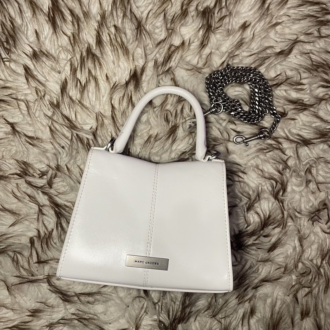 Marc Jacobs White Leather Top Handle Bag with Chain Strap (Category: Luxury Bags & Wallets) located in Marikina City. Submitted by nqshop (Listing ID 1464477370, Image 3). Description: - Authentic Marc Jacobs white leather handbag - Features a silver chain detail on the front flap - Comes with a detachable silver chain strap - Interior is clean - Minimal signs of wear - Versatile for day or night use -With dust bag Shipped from U.S Original Price