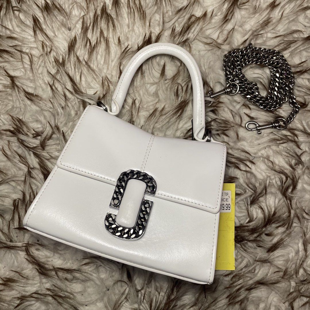 Marc Jacobs White Leather Top Handle Bag with Chain Strap (Category: Luxury Bags & Wallets) located in Marikina City. Submitted by nqshop (Listing ID 1464477370, Image 2). Description: - Authentic Marc Jacobs white leather handbag - Features a silver chain detail on the front flap - Comes with a detachable silver chain strap - Interior is clean - Minimal signs of wear - Versatile for day or night use -With dust bag Shipped from U.S Original Price