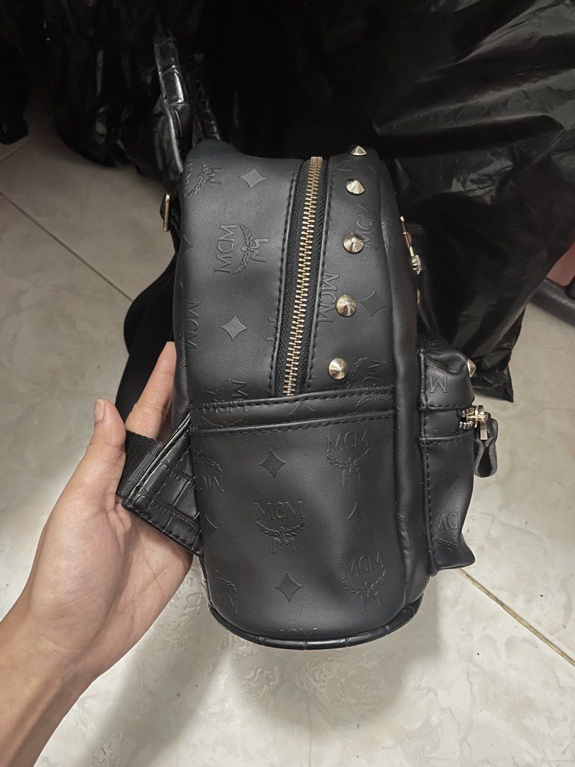MCM Studded Monogram Mini Backpack Black (Category: Luxury Bags & Wallets) located in Cagayan de Oro. Submitted by luxieebags (Listing ID 1464547742, Image 3). Description: - Authentic MCM mini backpack - All-over signature monogram print - Elegant gold stud detailing - Convenient front zip pocket - Spacious main compartment - Adjustable shoulder straps for comfort - Ideal for everyday errands or travel adventures.