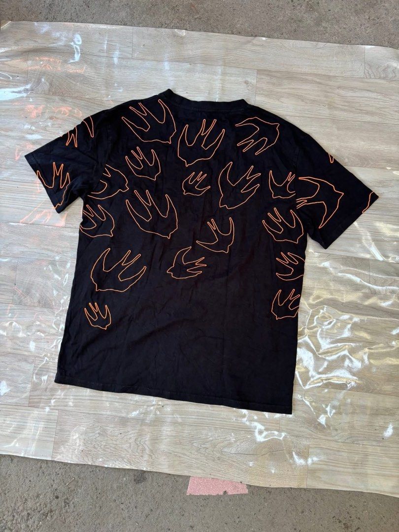 MCQ Swallow Print Black T-Shirt (Category: Tshirts & Polo Shirts ) located in Manila. Submitted by noribrahim.20 (Listing ID 1464477240, Image 2). Description: - Brand: MCQ - Color: Black with all-over orange swallow print - Style: Short sleeves, crew neck - Origin: Made in Turkey - Size: XL - Occasion: Great for casual wear.