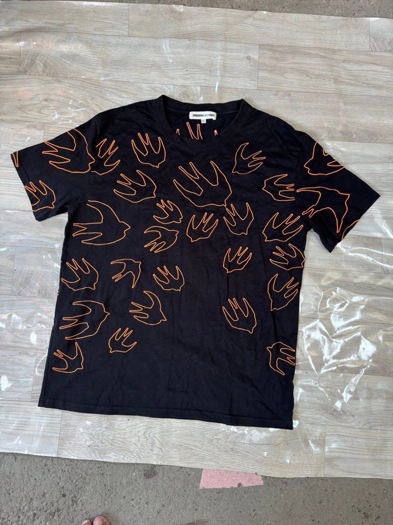 MCQ Swallow Print Black T-Shirt (Category: Tshirts & Polo Shirts ) located in Manila. Submitted by noribrahim.20 (Listing ID 1464477240, Image 1). Description: - Brand: MCQ - Color: Black with all-over orange swallow print - Style: Short sleeves, crew neck - Origin: Made in Turkey - Size: XL - Occasion: Great for casual wear.