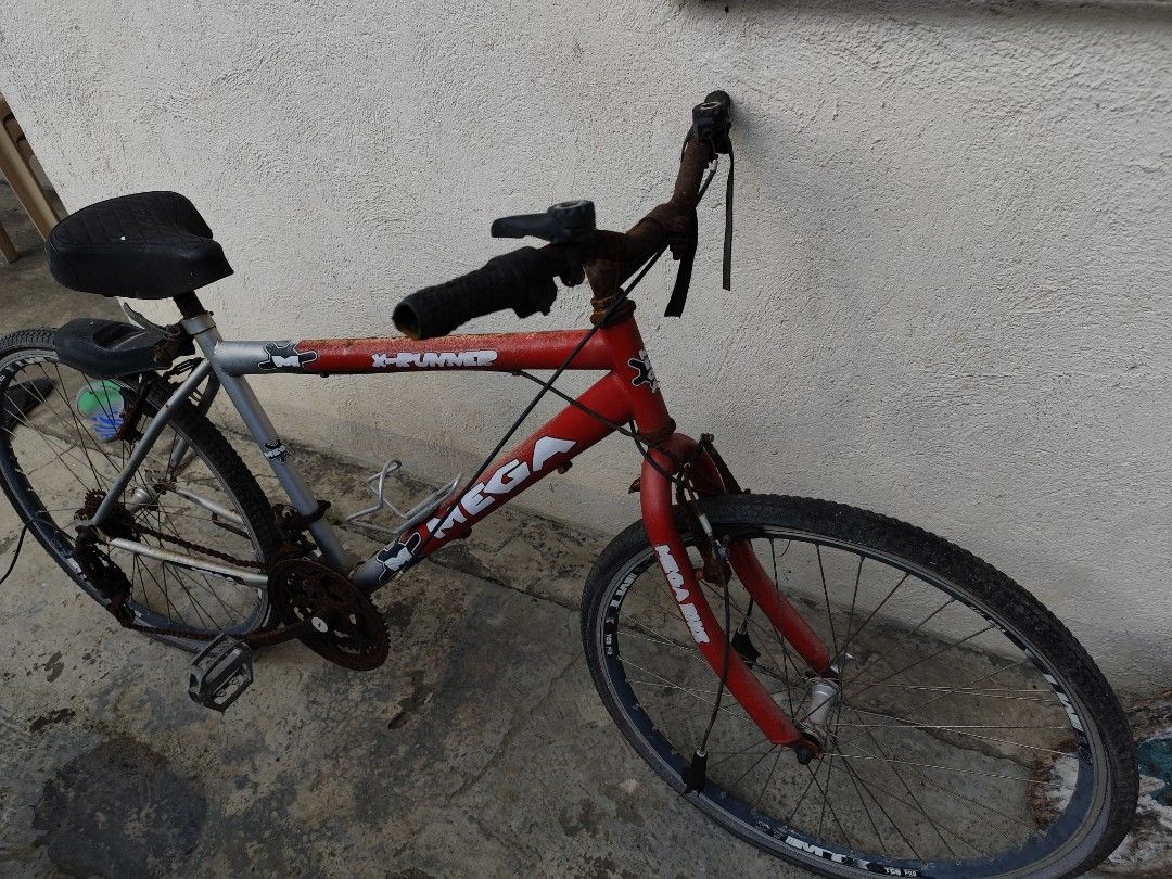 Mega X-Runner Mountain Bike (Category: Bicycles) located in Caloocan City. Submitted by vongabriel33911 (Listing ID 1464359919, Image 2). Description: -1000 Negotiable price 💸💸 -Heavily used -Scrap bike -Brand and Model: Mega X-Runner. -Frame: Red and silver diamond-style steel frame. -Wheels: 26-inch rims with knobby all-terrain tires. -Drivetrain: Multi-speed gear system with handlebar shifters..