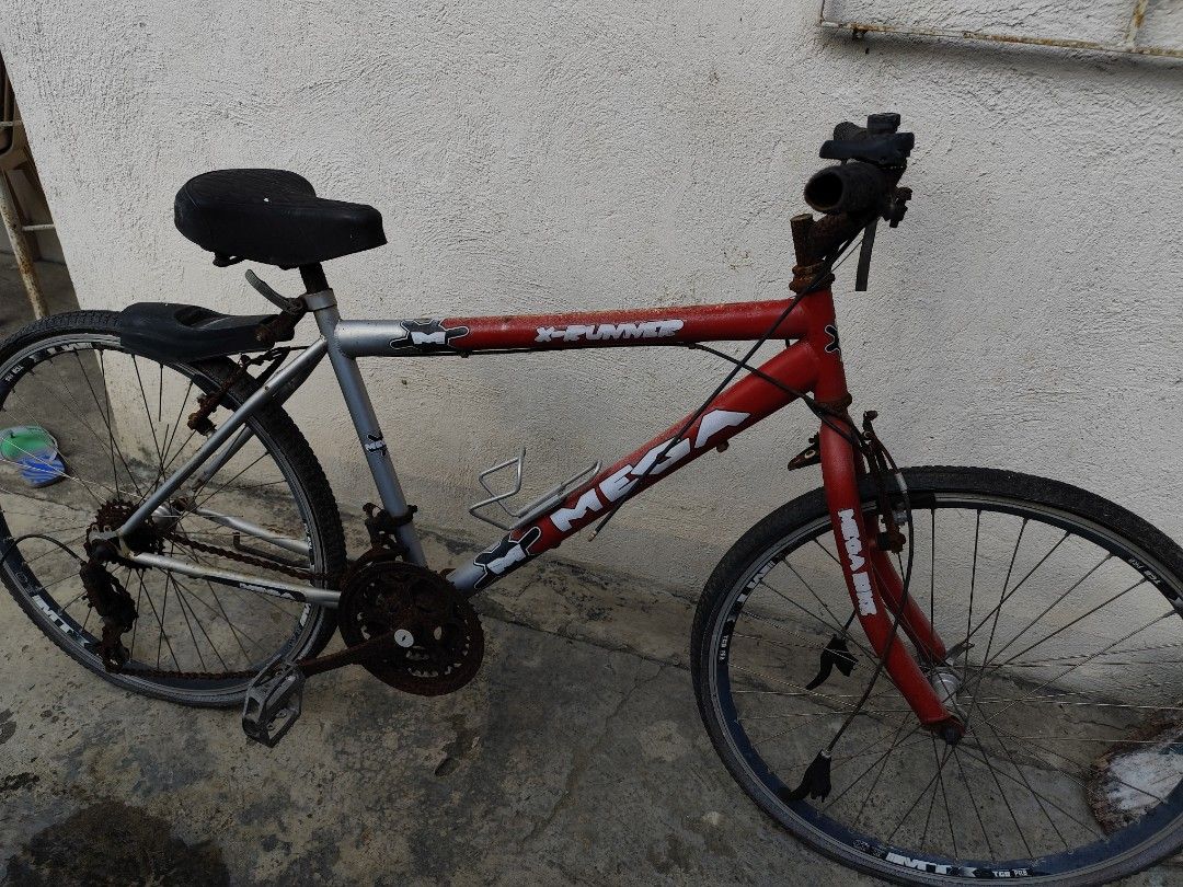 Mega X-Runner Mountain Bike (Category: Bicycles) located in Caloocan City. Submitted by vongabriel33911 (Listing ID 1464359919, Image 1). Description: -1000 Negotiable price 💸💸 -Heavily used -Scrap bike -Brand and Model: Mega X-Runner. -Frame: Red and silver diamond-style steel frame. -Wheels: 26-inch rims with knobby all-terrain tires. -Drivetrain: Multi-speed gear system with handlebar shifters..
