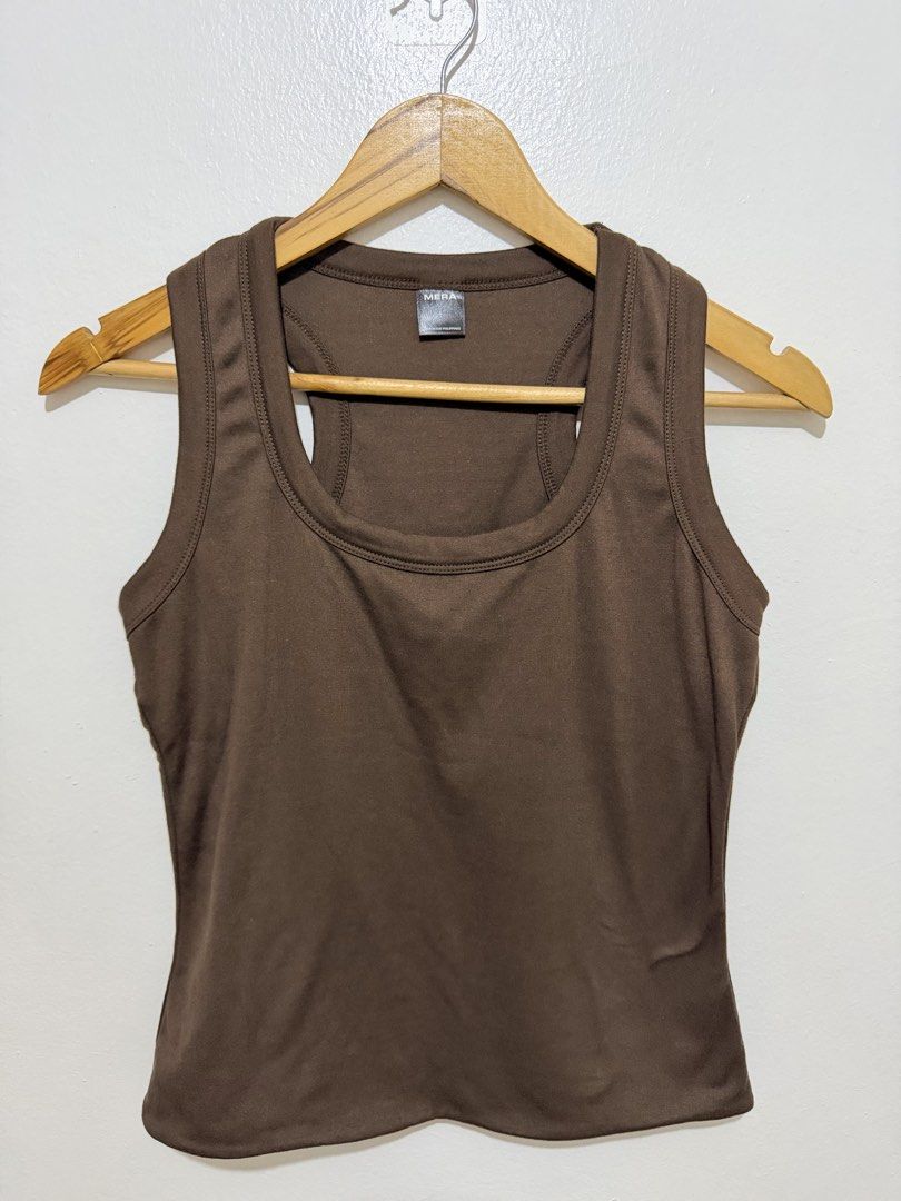 MERA Brown Racerback Tank Top (Category: Sleeveless) located in Caloocan City. Submitted by ashpreloves (Listing ID 1464380796, Image 1). Description: - Brand: MERA - Style: Racerback Tank Top - Color: Brown - Features: Simple, classic design, good for layering or wearing on its own - Material: Soft fabric - Fit: Comfortable - Origin: Made in the Philippines.