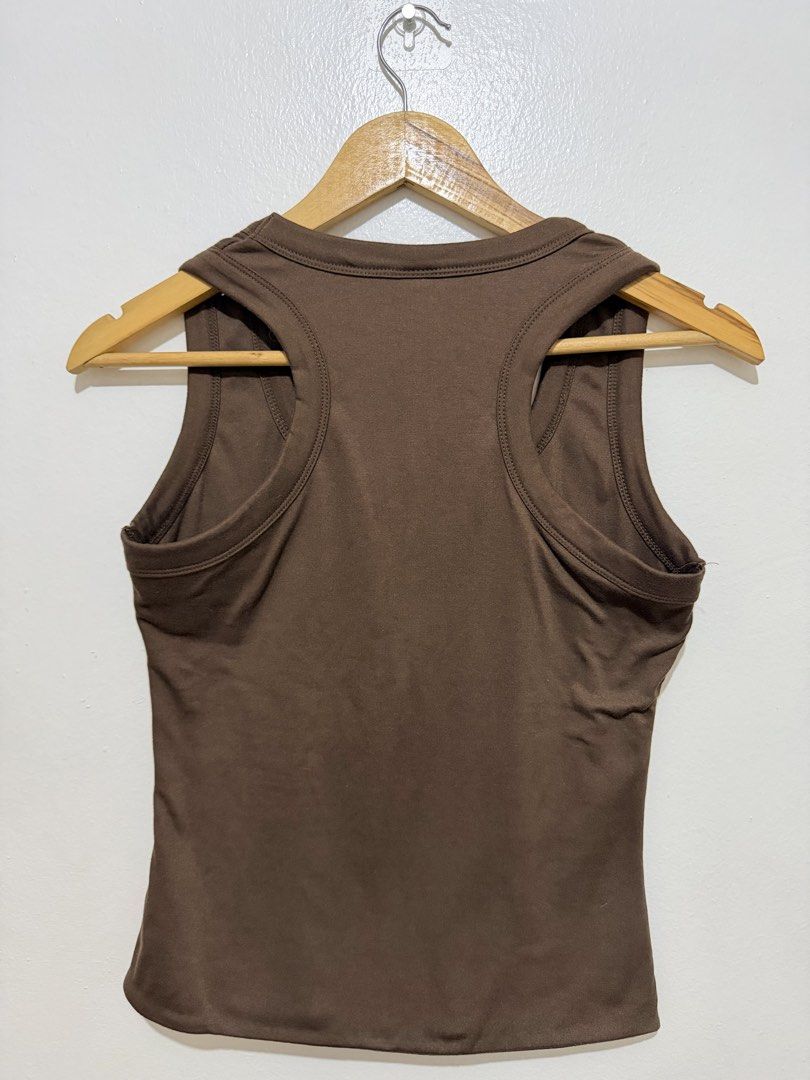 MERA Brown Racerback Tank Top (Category: Sleeveless) located in Caloocan City. Submitted by ashpreloves (Listing ID 1464380796, Image 3). Description: - Brand: MERA - Style: Racerback Tank Top - Color: Brown - Features: Simple, classic design, good for layering or wearing on its own - Material: Soft fabric - Fit: Comfortable - Origin: Made in the Philippines.
