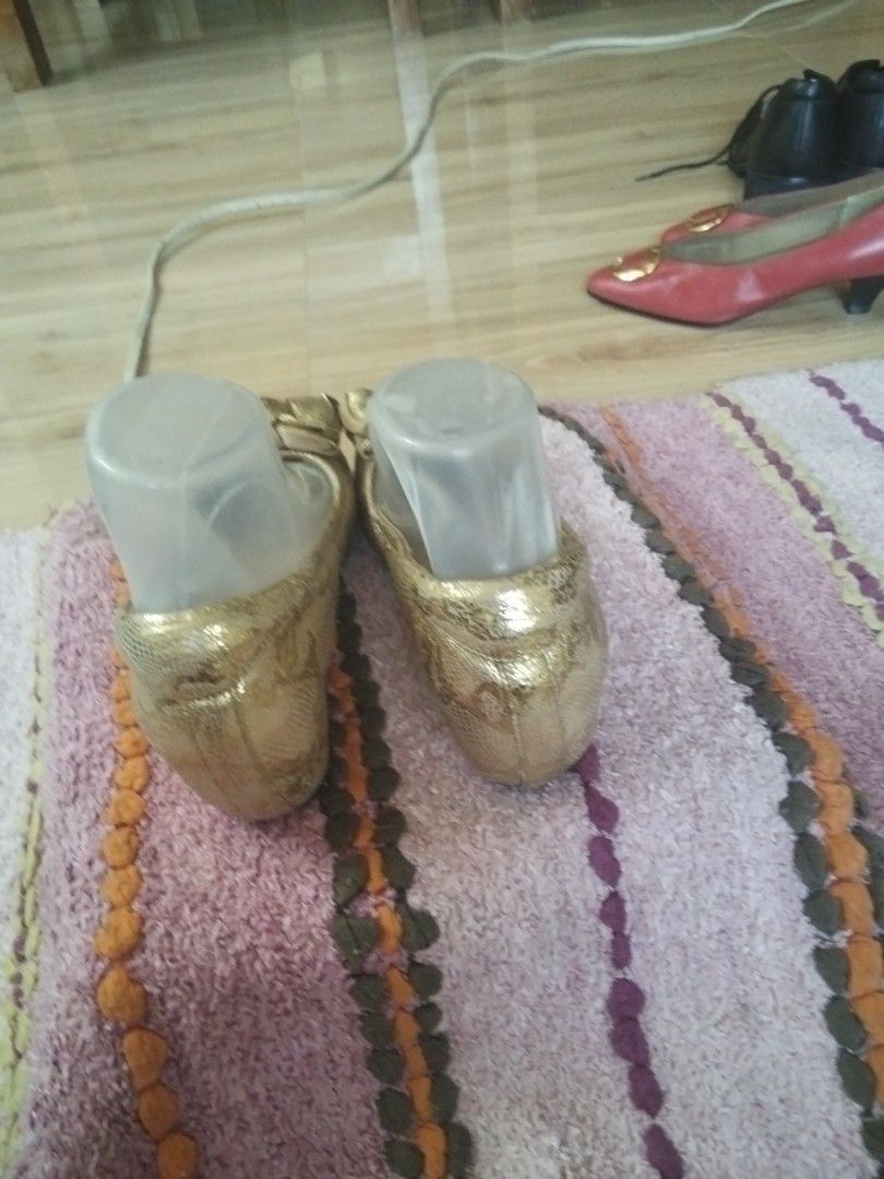 Metallic gold heeled shoes (Category: Heels) located in Calasiao. Submitted by alluringvenus.thriftshop (Listing ID 1464414597, Image 3). Description: very good condition Brand name is not seen any more.