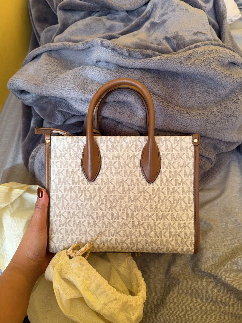 Michael Kors - Medium Tote Bag (Authentic) (Category: Tote Bags) located in Bacoor. Submitted by sonnybbs (Listing ID 1464359584, Image 2). Description: - Authentic Michael Kors tote bag - Signature MK print with tan leather trim and handles - Secure zipper closure - Interior pockets for organization - Detachable crossbody strap for versatile wear - Ideal for everyday use - There is a little leather chip off please see last images (the rest ok) r
