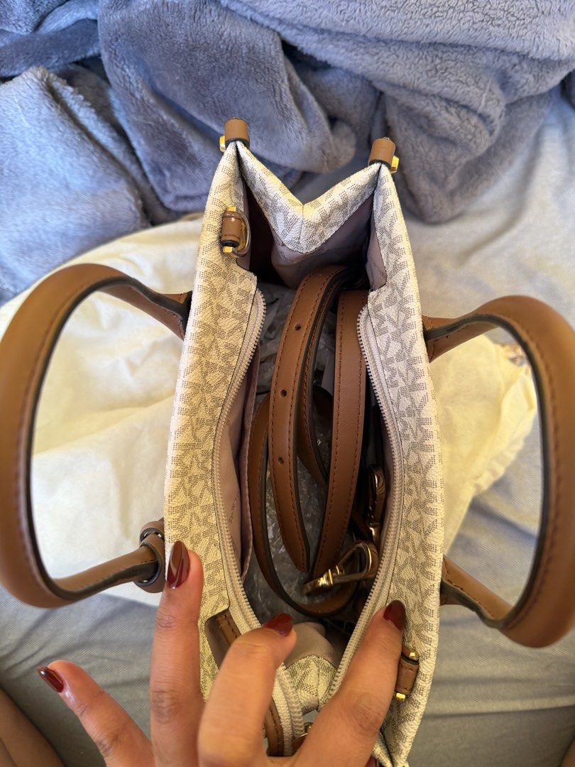 Michael Kors - Medium Tote Bag (Authentic) (Category: Tote Bags) located in Bacoor. Submitted by sonnybbs (Listing ID 1464359584, Image 3). Description: - Authentic Michael Kors tote bag - Signature MK print with tan leather trim and handles - Secure zipper closure - Interior pockets for organization - Detachable crossbody strap for versatile wear - Ideal for everyday use - There is a little leather chip off please see last images (the rest ok) r