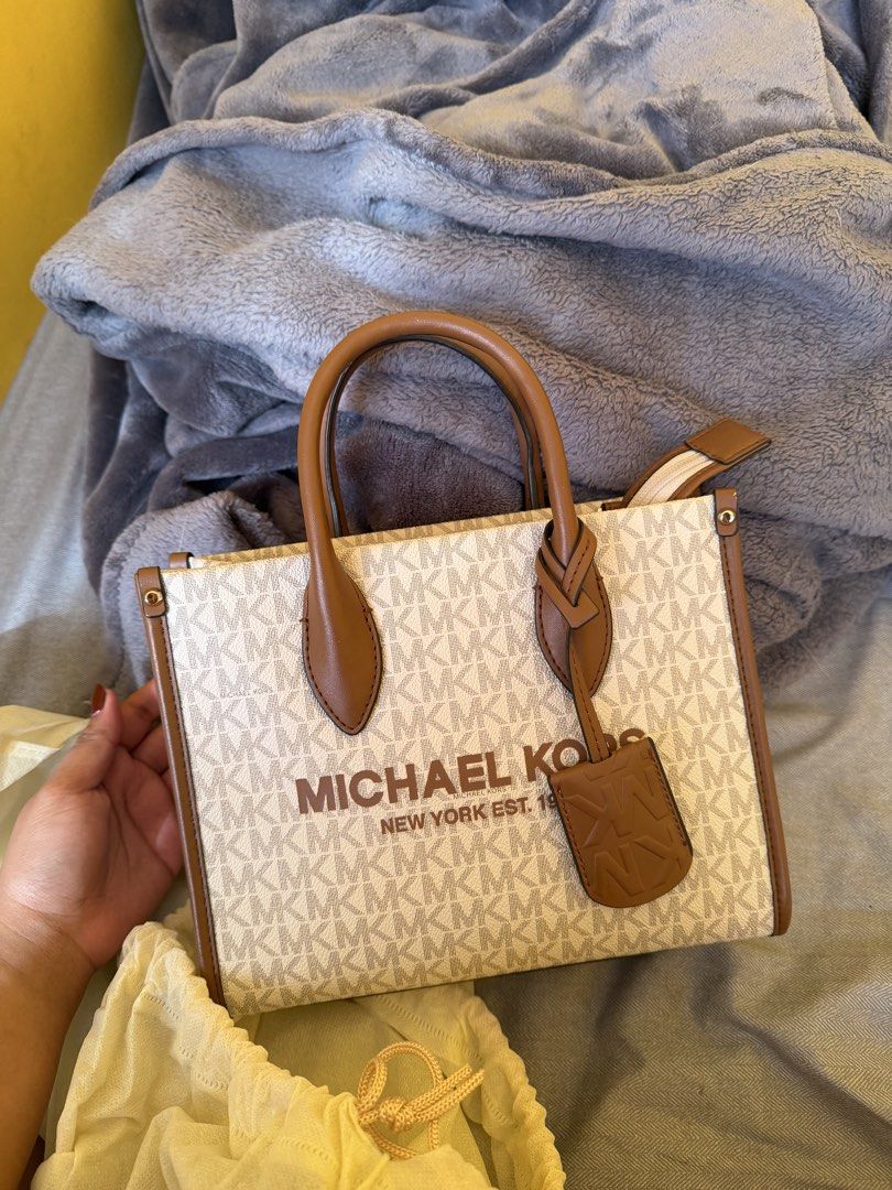 Michael Kors - Medium Tote Bag (Authentic) (Category: Tote Bags) located in Bacoor. Submitted by sonnybbs (Listing ID 1464359584, Image 1). Description: - Authentic Michael Kors tote bag - Signature MK print with tan leather trim and handles - Secure zipper closure - Interior pockets for organization - Detachable crossbody strap for versatile wear - Ideal for everyday use - There is a little leather chip off please see last images (the rest ok) r
