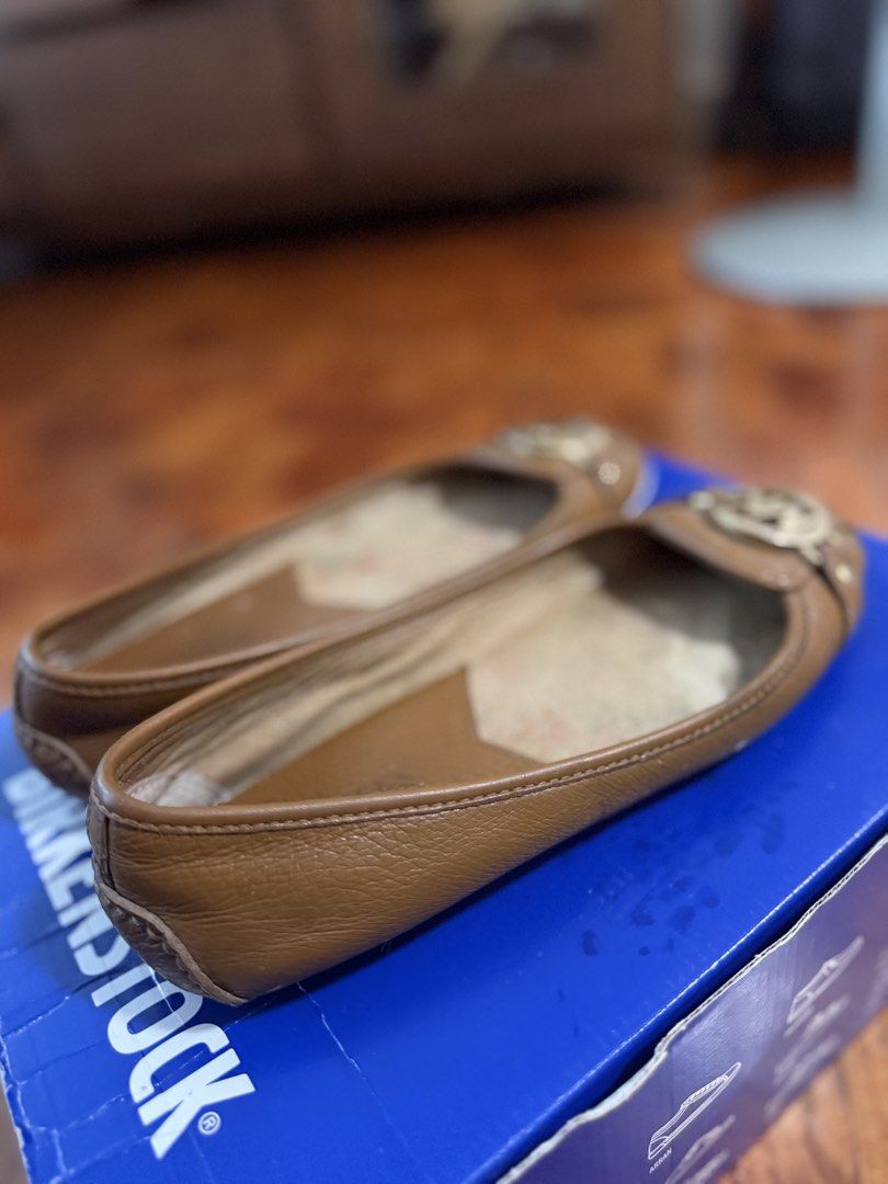 Michael Kors Brown Leather MK Logo Ballet Flats (Category: Flats & Sandals) located in Paranaque City. Submitted by ferrewr (Listing ID 1464410832, Image 2). Description: - Michael Kors brown leather ballet flats - Iconic MK logo hardware on the front - Comfortable slip-on style - Soles show some wear - Classic design, perfect for casual or dressing up an outfit - Ready for a new home.