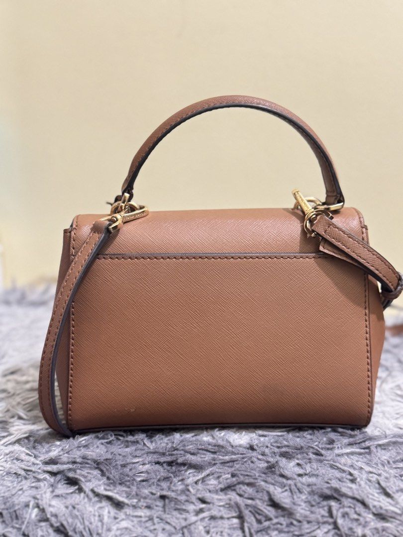 Michael Kors Brown Leather Top Handle Bag (Category: Luxury Bags & Wallets) located in Batangas. Submitted by bagsbyann (Listing ID 1464361545, Image 2). Description: - Authentic Michael Kors handbag in a stylish brown hue. - Crafted from durable Saffiano leather with elegant gold hardware. - Versatile carrying options: comfortable top handle and a detachable shoulder strap. - Interior features a secure zip pocket and convenient slip pockets for 