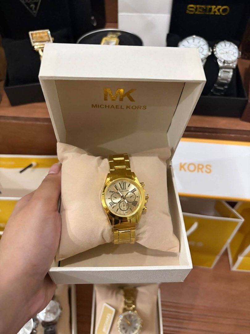 Michael Kors Gold Chronograph Watch (Category: Women's Watches) located in Balanga. Submitted by forevercloset.new (Listing ID 1464465186, Image 1). Description: - Authentic Gold Michael Kors Watch - Classic Chronograph Style - Elegant Roman Numeral Dial - Includes Original Box - Perfect for both casual and formal wear - A timeless addition to any collection.