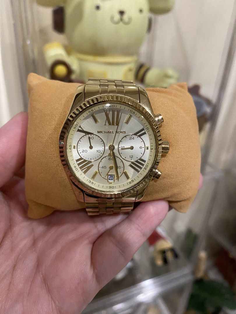 Michael Kors Gold Chronograph Watch (Category: Women's Watches) located in Manila. Submitted by m.dptan (Listing ID 1464535405, Image 1). Description: - Genuine Gold Michael Kors Watch - Features Chronograph Function - Includes Date Display - Elegant Roman Numeral Dial - Durable Stainless Steel Band with MK Clasp - Versatile for both formal and casual wear - Selling as it's rarely used.