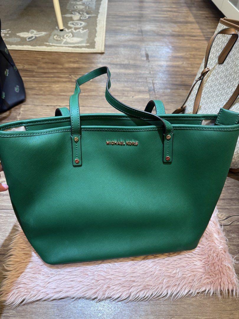 Michael Kors Green Leather Tote Bag (Category: Tote Bags) located in Dasmarinas. Submitted by rinz0man (Listing ID 1464403171, Image 3). Description: - Genuine Michael Kors tote bag in a stylish green hue. - Crafted from durable saffiano leather. - Elegant gold-tone hardware accents. - Interior includes a secure zip pocket and multiple slip pockets for organization. - Spacious design, ideal for carrying daily essentials. - Versatile for both prof