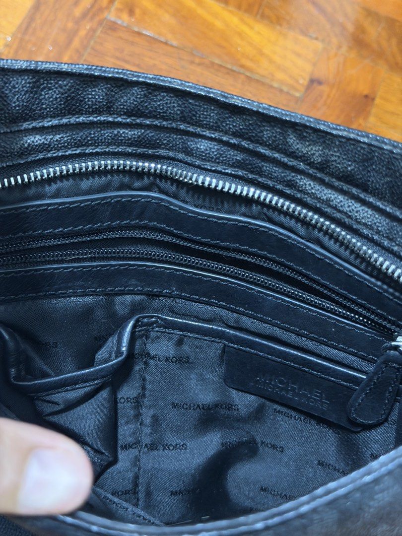 Michael Kors Monogram Sling Bag Black (Category: Luxury Bags & Wallets) located in Paranaque City. Submitted by ferrewr (Listing ID 1464451801, Image 2). Description: - Authentic Michael Kors shoulder bag in black. - Features the iconic all-over MK monogram pattern. - Elegant silver hardware with a "Michael Kors Est. 1981" plate. - Spacious interior with multiple zip pockets and compartments for organization. - Adjustable strap for comfortable we