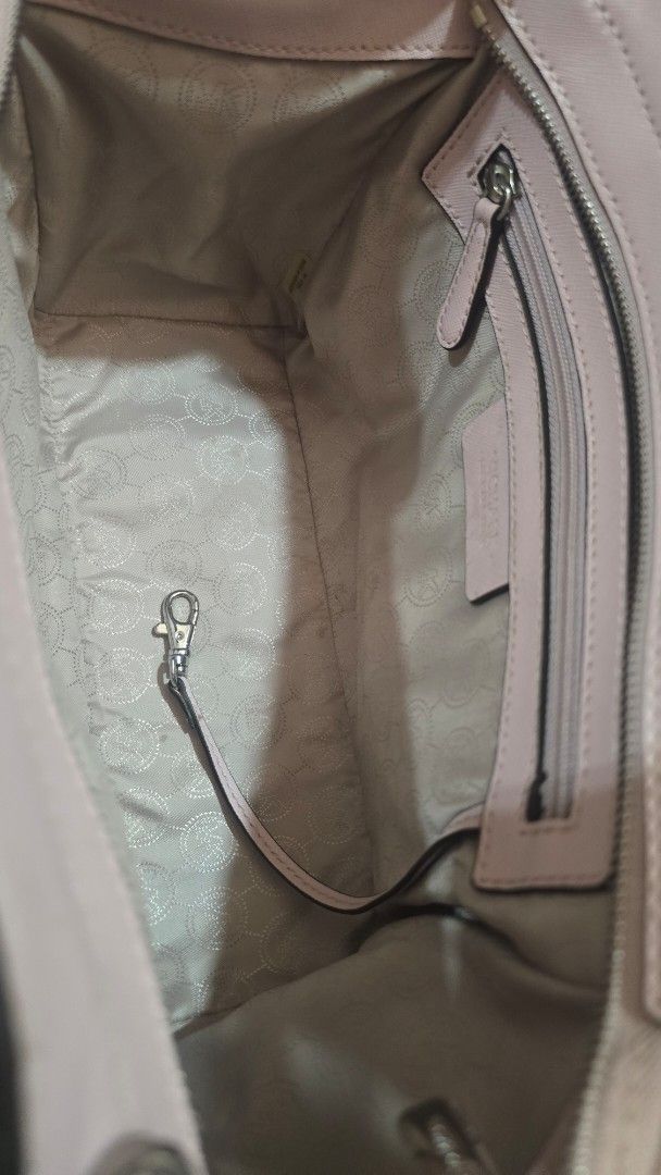 Michael Kors Pink Leather Studded Satchel Bag (Category: Luxury Bags & Wallets) located in Quezon City. Submitted by mbpreloved65 (Listing ID 1464367940, Image 2). Description: - Michael Kors satchel bag - Lovely light pink color - Silver stud detailing on sides - Top handles - Detachable shoulder strap - Interior zip pocket - Interior key clip - Clean inside and out - Great everyday bag.