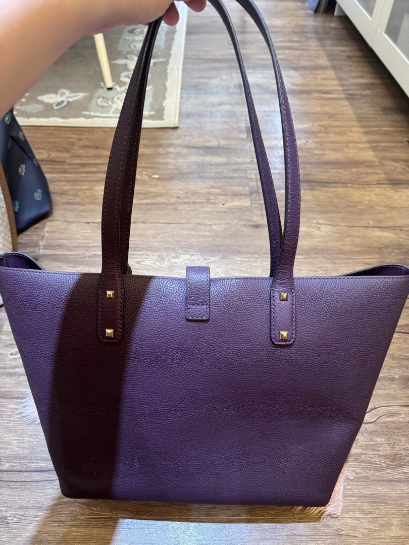 Michael Kors Purple Leather Tote Bag (Category: Tote Bags) located in Dasmarinas. Submitted by rinz0man (Listing ID 1464402763, Image 2). Description: - Stylish purple leather tote bag - Elegant gold hardware details - Secure magnetic snap closure - Comes with a small leather tag - Ample interior space - Ideal for everyday errands or travel.