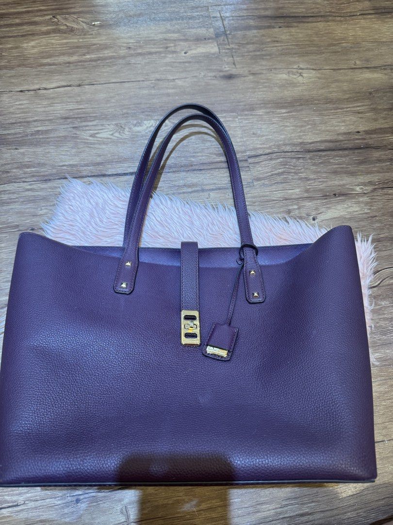 Michael Kors Purple Leather Tote Bag (Category: Tote Bags) located in Dasmarinas. Submitted by rinz0man (Listing ID 1464402763, Image 3). Description: - Stylish purple leather tote bag - Elegant gold hardware details - Secure magnetic snap closure - Comes with a small leather tag - Ample interior space - Ideal for everyday errands or travel.
