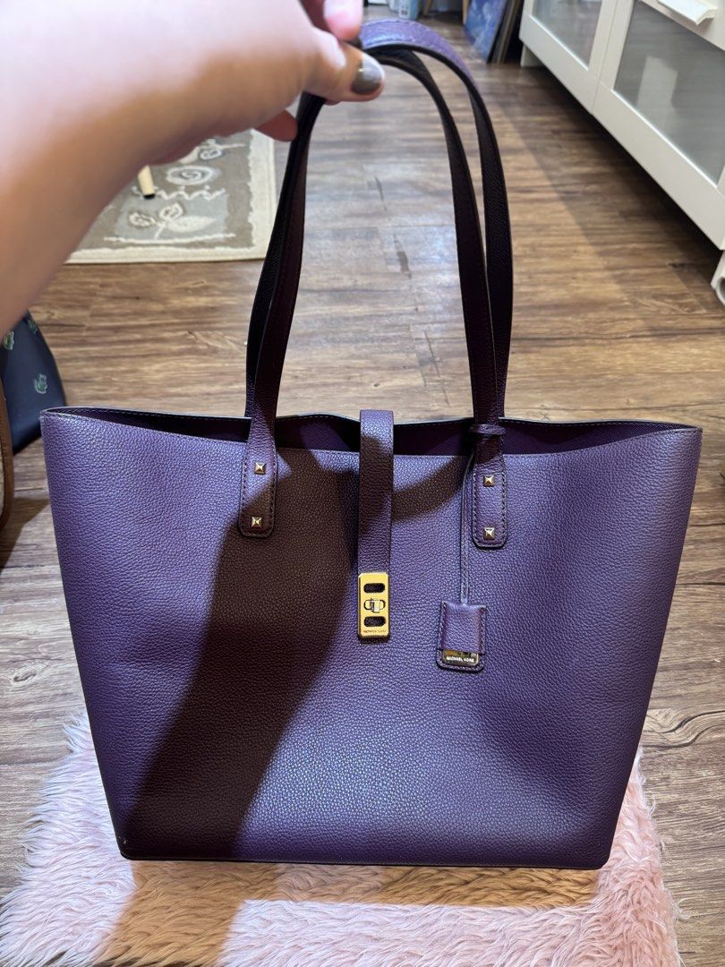 Michael Kors Purple Leather Tote Bag (Category: Tote Bags) located in Dasmarinas. Submitted by rinz0man (Listing ID 1464402763, Image 1). Description: - Stylish purple leather tote bag - Elegant gold hardware details - Secure magnetic snap closure - Comes with a small leather tag - Ample interior space - Ideal for everyday errands or travel.