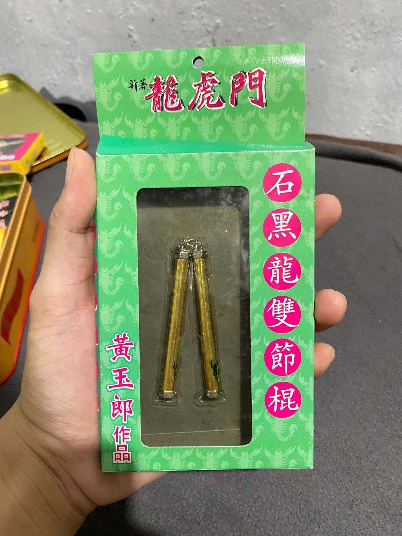 Miniature Sword nunchaku Dragon Tiger Gate (Category: Vintage Collectibles) located in Taguig. Submitted by jeannecaye57818 (Listing ID 1464475801, Image 1). Description: rare, vintage Dragon Tiger Gate (龍虎門) miniature weapon collectible. This item features the signature gold-colored Nunchaku (雙節棍) belonging to the iconic main character, Shek Hark-lung (石黑龍).Created by legendary Hong Kong manhua artist Tony Wong (黃玉郎), this item was originally re