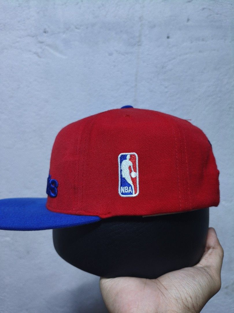 Mitchell & Ness Washington Bullets Snapback Cap (Category: Caps & Hats) located in Malilipot. Submitted by aronbigorn96320 (Listing ID 1464470329, Image 3). Description: - Mitchell & Ness Washington Bullets snapback cap - Classic red and blue colorway - Features embroidered 'Bullets' logo on front - 'Mitchell & Ness' embroidered on the back - NBA logo detail on the side - Adjustable snapback closure for a custom fit - Ideal for any Washington Bul